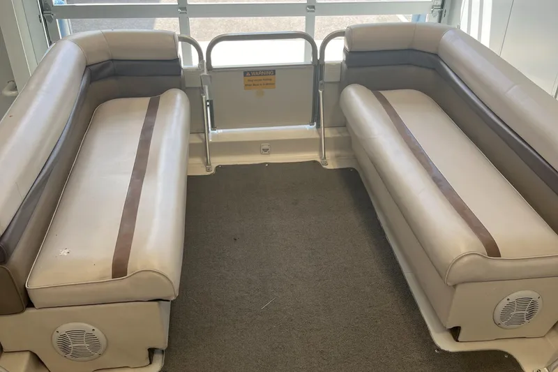 Slide: The Image of Interior seating of a 1997 Hurricane 226 RE OB boat, featuring beige and brown upholstery. - 10