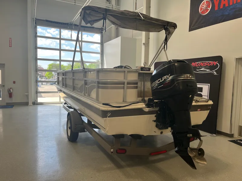 Slide: The Image of 1997 Hurricane 226 RE OB boat with Mercury outboard motor in a showroom. - 4