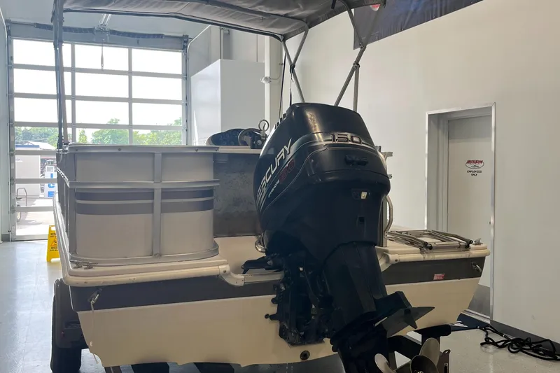 Slide: The Image of 1997 Hurricane 226 RE OB boat with Mercury outboard motor in a garage setting. - 5