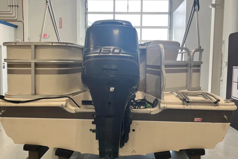 Slide: The Image of 1997 Hurricane 226 RE OB boat with 150 HP outboard motor in a garage. - 6