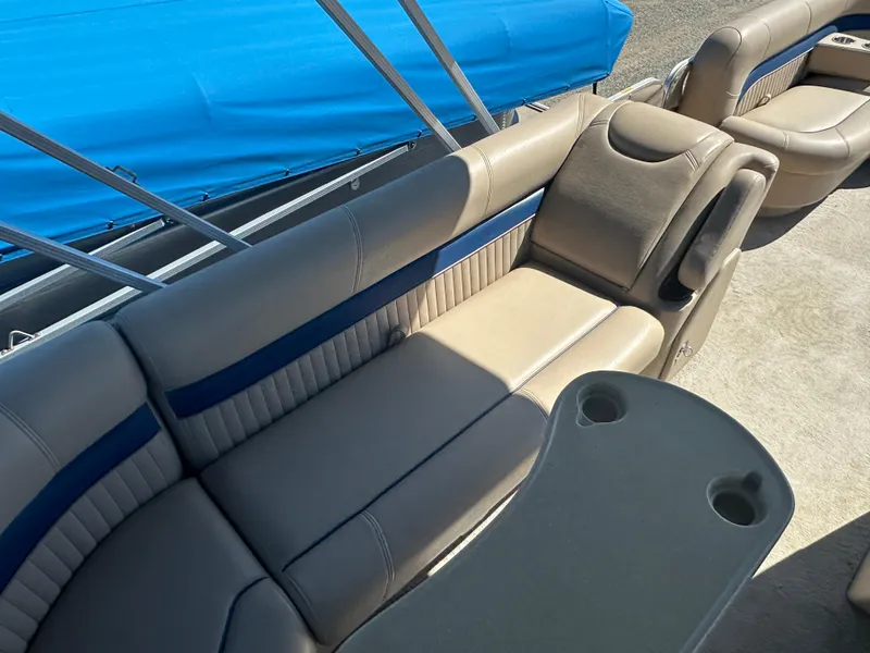 Slide: The Image of 2008 Godfrey AquaPatio 22 boat interior with beige seating and blue accents. - 11