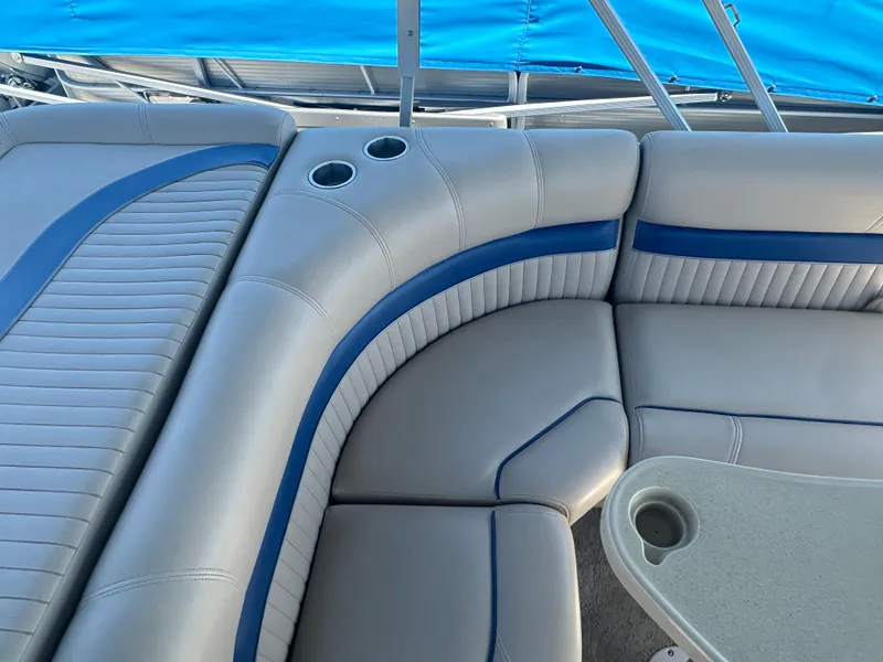 Slide: The Image of Luxurious seating on 2008 Godfrey AquaPatio 22 pontoon boat with blue accents and cup holders. - 12