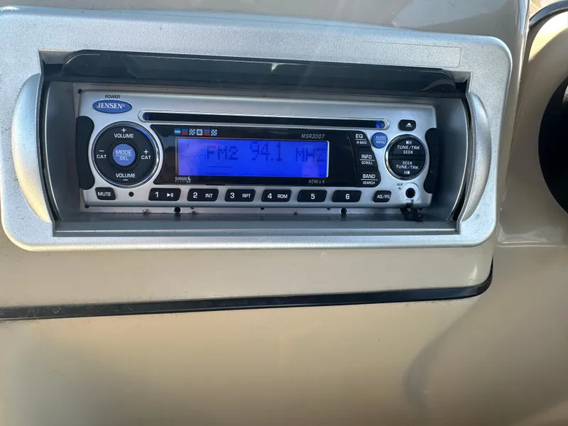 Slide: The Image of Jensen stereo system in a 2008 Godfrey AquaPatio 22, displaying FM 94.1 MHz. - 16