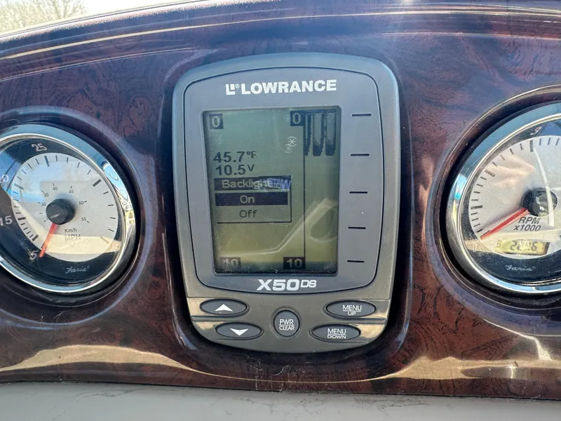 Slide: The Image of Lowrance X50 DS fishfinder on 2008 Godfrey AquaPatio 22 dashboard with gauges. - 17