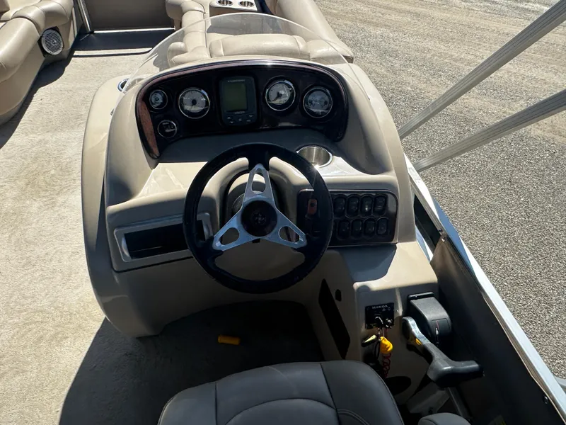 Slide: The Image of 2008 Godfrey AquaPatio 22 boat dashboard with steering wheel and control panel. - 9