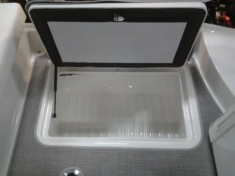 Slide: The Image of 2018 Formula 310 Bowrider storage compartment with open lid, showcasing interior space. - 19