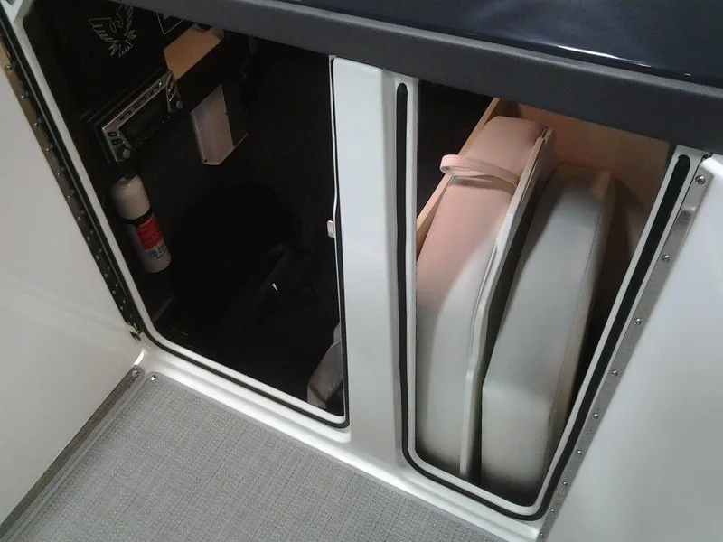 Slide: The Image of 2018 Formula 310 Bowrider storage compartments with cushions and fire extinguisher. - 31