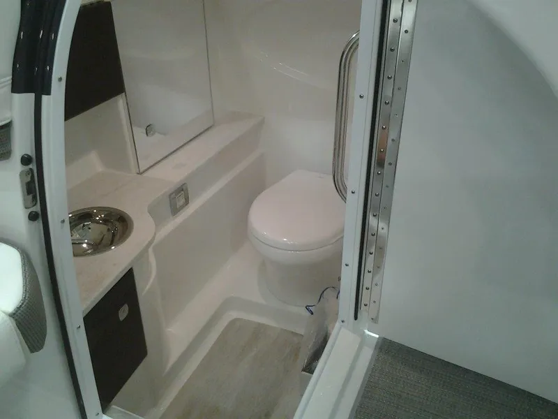 Slide: The Image of 2018 Formula 310 Bowrider interior bathroom with toilet and sink. - 33