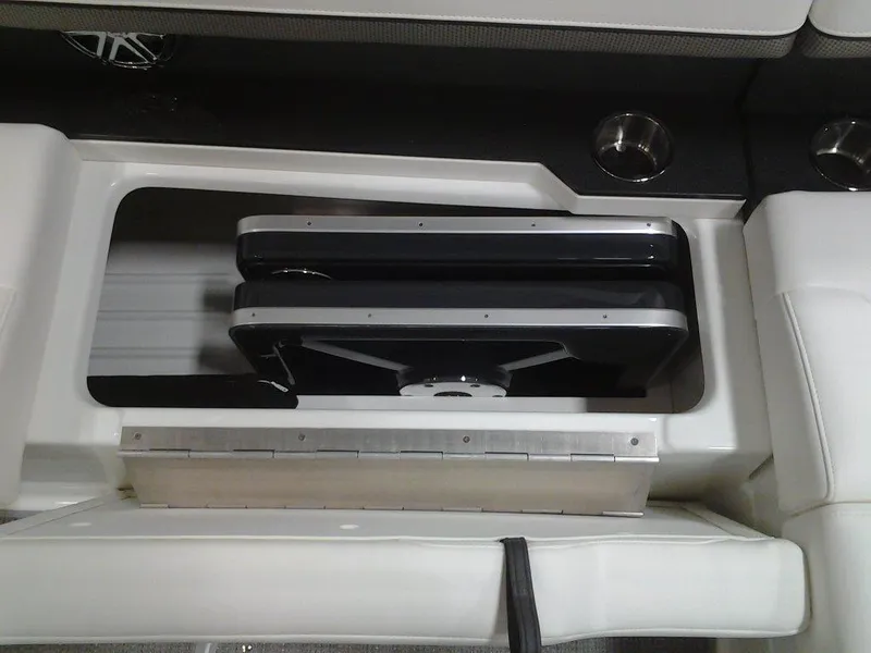 Slide: The Image of 2018 Formula 310 Bowrider interior storage compartment with sleek design and cup holders. - 35