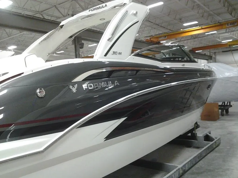 Slide: The Image of 2018 Formula 310 Bowrider boat in a showroom, showcasing sleek design and modern features. - 6