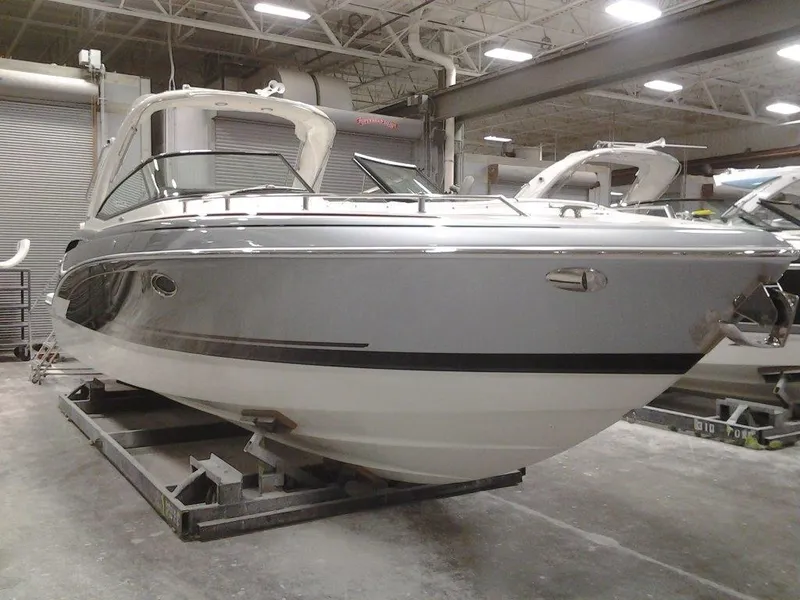 Slide: The Image of 2018 Formula 310 Bowrider boat in a warehouse setting. - 7