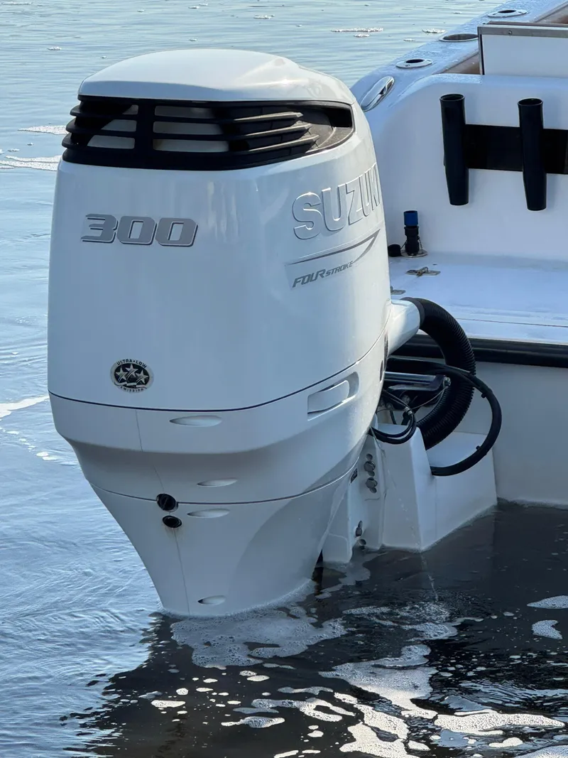 Slide: The Image of 2023 Twin Vee 280 GFX CC with Suzuki 300 outboard engine in water. - 11