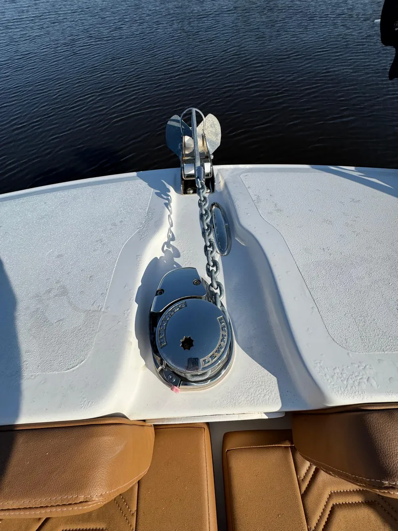 Slide: The Image of 2023 Twin Vee 280 GFX CC boat anchor system on deck by the water. - 20