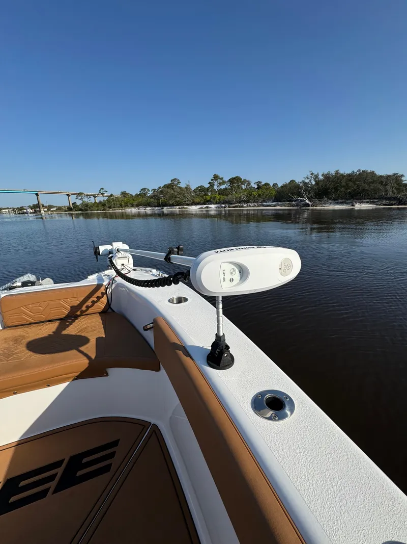 Slide: The Image of 2023 Twin Vee 280 GFX CC boat on calm water, featuring sleek design and modern equipment. - 23