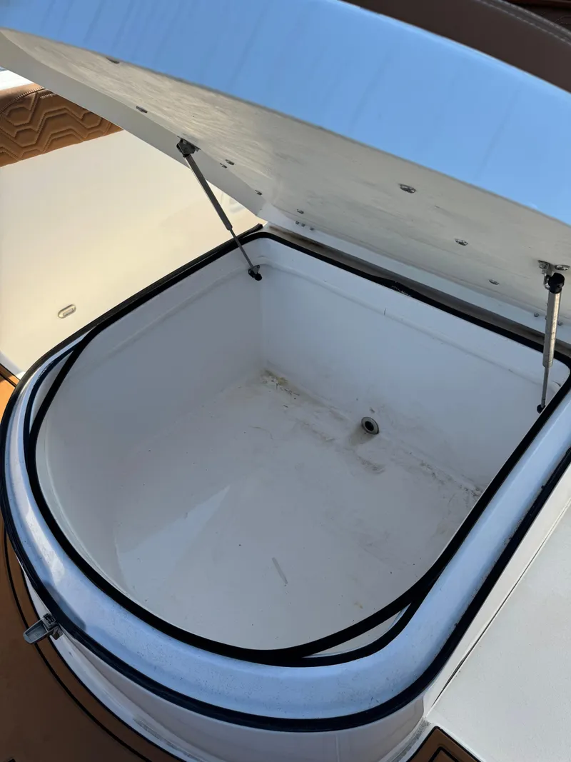 Slide: The Image of 2023 Twin Vee 280 GFX CC boat storage compartment, open lid, spacious interior. - 25