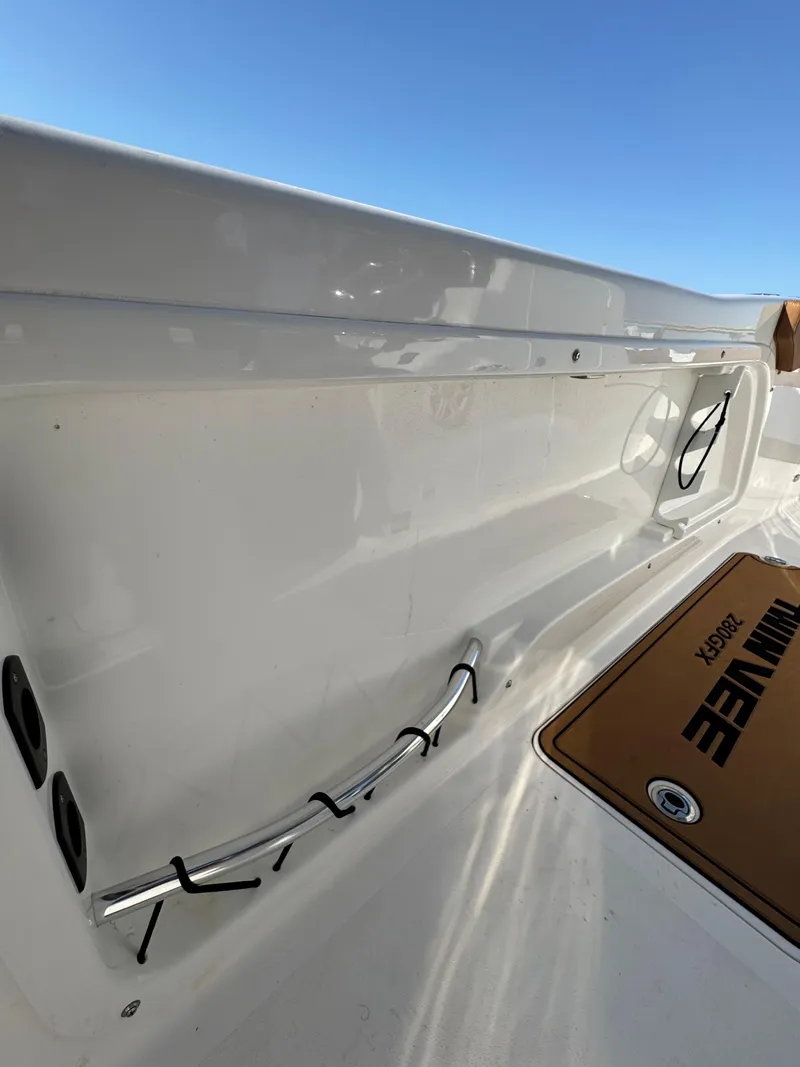 Slide: The Image of 2023 Twin Vee 280 GFX CC boat interior with sleek white finish and branded mat. - 33