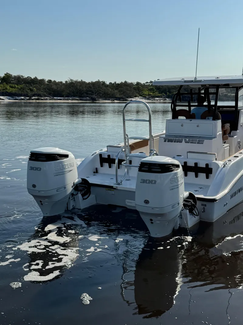 Slide: The Image of 2023 Twin Vee 280 GFX CC boat with dual engines on calm water. - 4