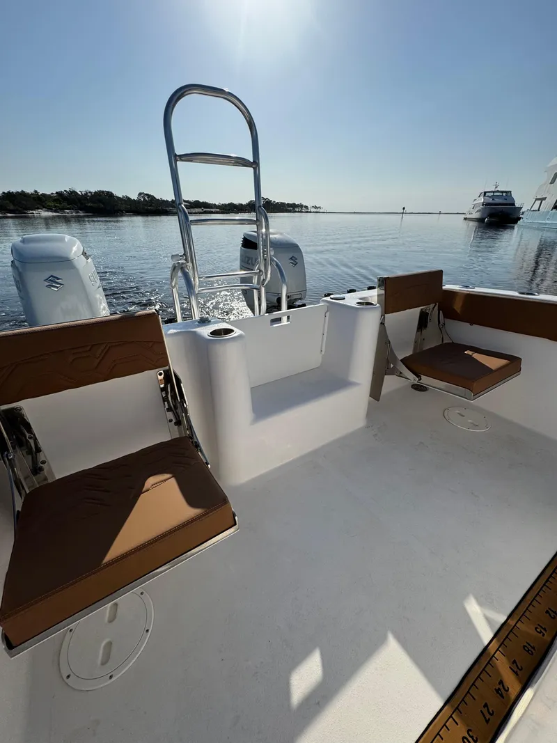 Slide: The Image of 2023 Twin Vee 280 GFX CC boat interior with seating, on calm water. - 43