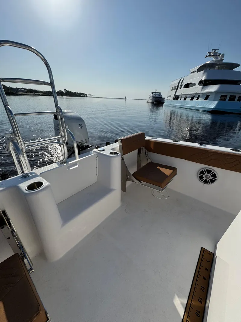 Slide: The Image of 2023 Twin Vee 280 GFX CC boat interior with ocean view and yachts in background. - 44