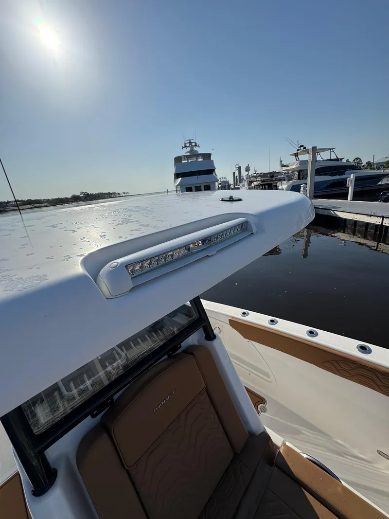 Slide: The Image of 2023 Twin Vee 280 GFX CC boat docked at marina under clear sky. - 47