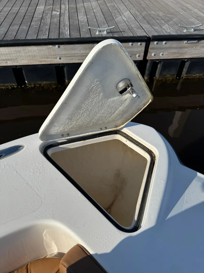 Slide: The Image of Open storage compartment on 2023 Twin Vee 280 GFX CC boat by the dock. - 48