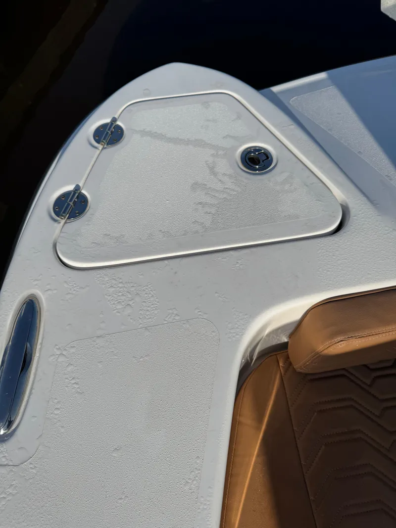 Slide: The Image of 2023 Twin Vee 280 GFX CC boat deck with storage compartment and seating. - 49