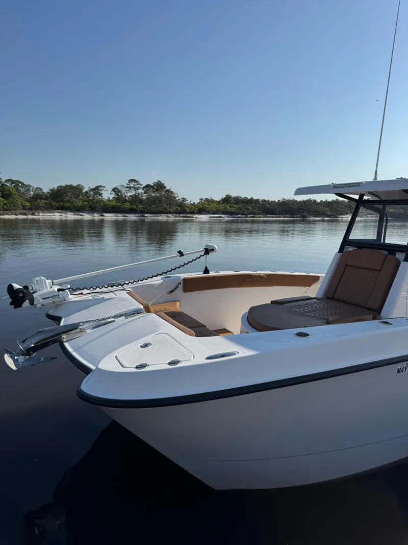 Slide: The Image of 2023 Twin Vee 280 GFX CC boat on calm water, featuring sleek design and spacious seating. - 9