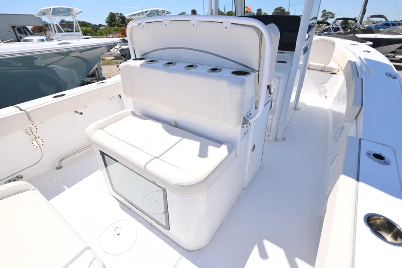 Slide: The Image of 2025 Sea Hunt Gamefish 27 Forward Seating boat interior with cushioned seating and storage. - 10