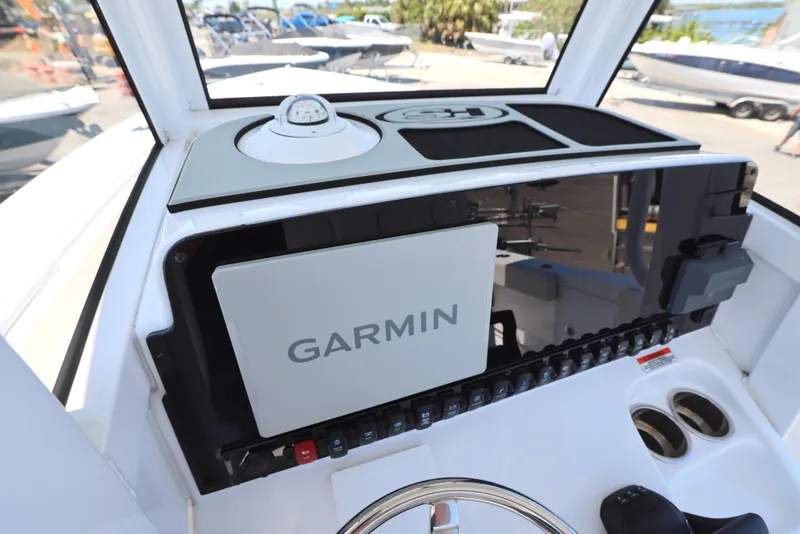 Slide: The Image of 2025 Sea Hunt Gamefish 27 dashboard with Garmin navigation system and controls. - 11