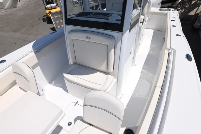 Slide: The Image of 2025 Sea Hunt Gamefish 27 Forward Seating boat interior with white cushioned seats. - 17