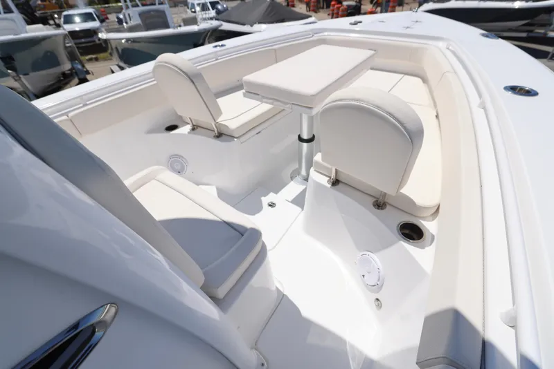 Slide: The Image of 2025 Sea Hunt Gamefish 27 Forward Seating, featuring spacious white seating and a central table. - 19