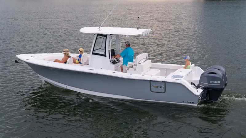 Slide: The Image of 2025 Sea Hunt Gamefish 27 boat cruising with passengers on calm water. - 22