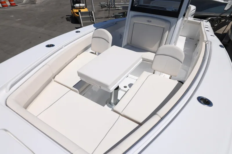 Slide: The Image of 2025 Sea Hunt Gamefish 27 Forward Seating with white cushioned seats and table. - 3