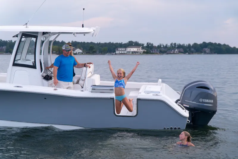 Slide: The Image of 2025 Sea Hunt Gamefish 27 boat with people enjoying water activities. - 30