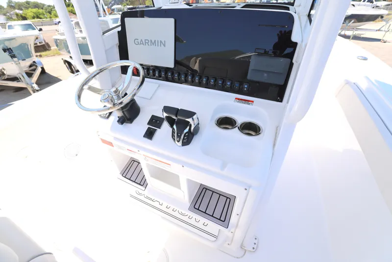 Slide: The Image of 2025 Sea Hunt Gamefish 27 helm with Garmin display and modern controls. - 4