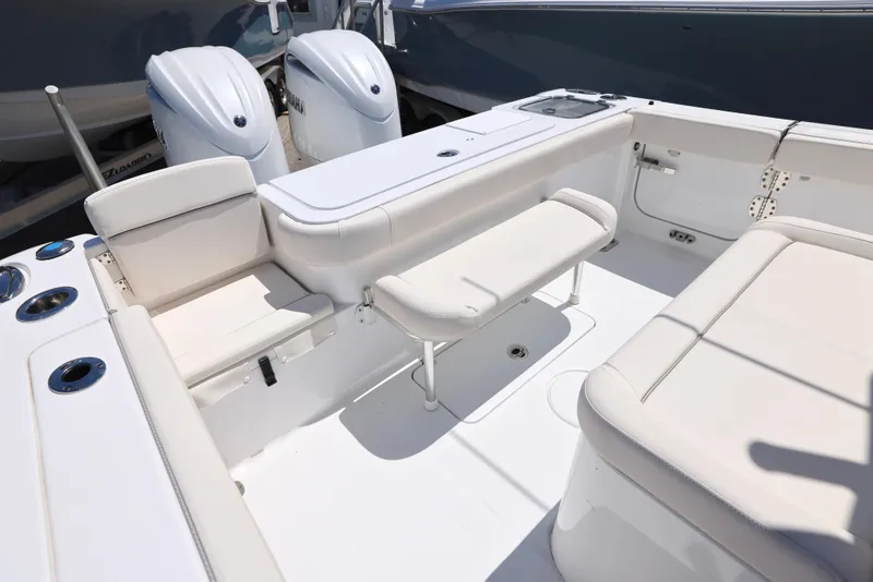Slide: The Image of 2025 Sea Hunt Gamefish 27 Forward Seating boat interior with dual engines and white cushioned seats. - 8