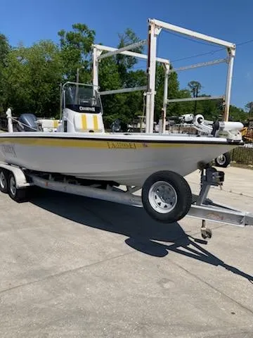 Slide: The Image of 2004 Champion 22 Bay Champ boat on trailer, parked outdoors. - 2