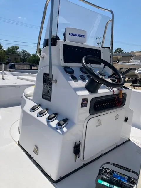 Slide: The Image of 2004 Champion 22 Bay Champ boat console with steering wheel and Lowrance navigation system. - 5