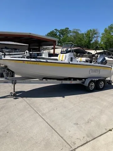 Slide: The Image of 2004 Champion 22 Bay Champ boat on trailer in outdoor storage area. - 6