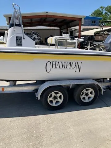 Slide: The Image of 2004 Champion 22 Bay Champ boat on trailer, parked outdoors. - 7