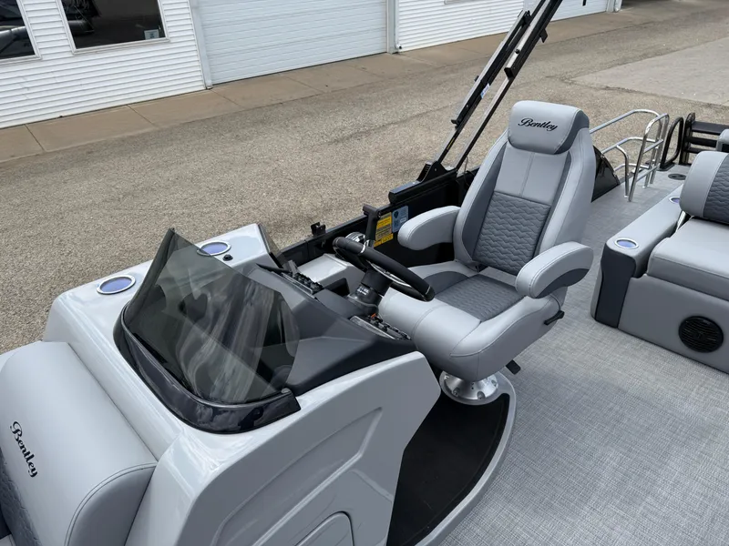 Slide: The Image of 2025 Bentley Pontoons Elite 223 Swingback Triple Log helm with luxurious seating and modern controls. - 16