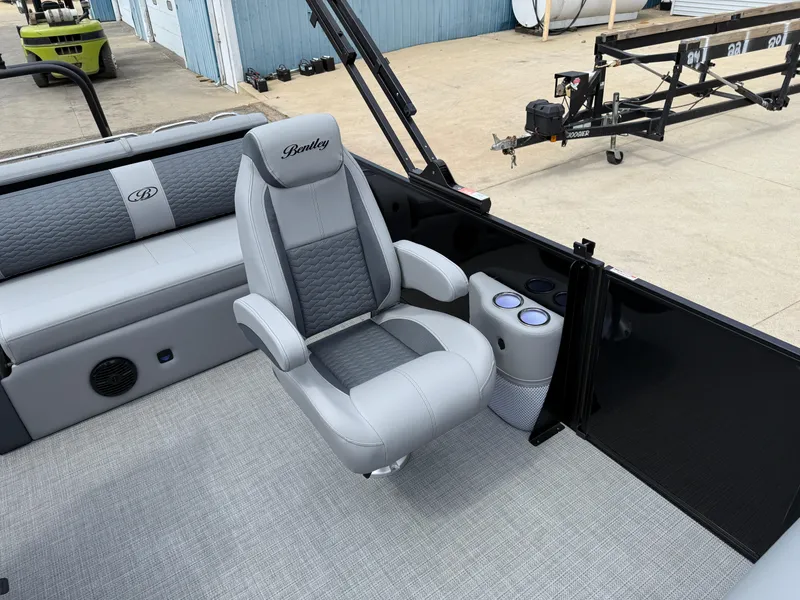 Slide: The Image of 2025 Bentley Pontoons Elite 223 Swingback Triple Log interior with luxury seating and cup holders. - 17