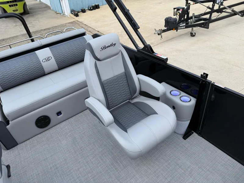 Slide: The Image of 2025 Bentley Pontoons Elite 223 Swingback Triple Log interior with luxurious seating and cup holders. - 22