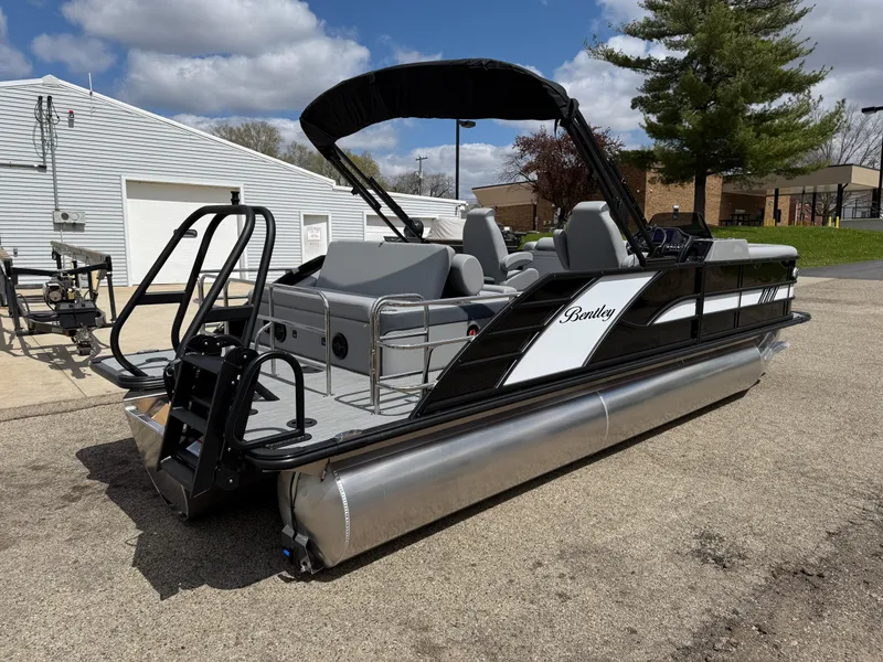 Slide: The Image of 2025 Bentley Pontoons Elite 223 Swingback Triple Log, sleek design, parked outdoors. - 7