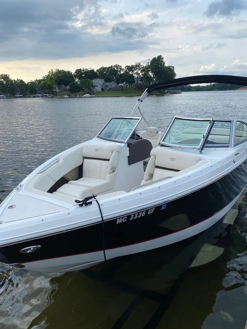 Slide: The Image of 2018 Cobalt R3 boat docked on a serene lake under a cloudy sky. - 3