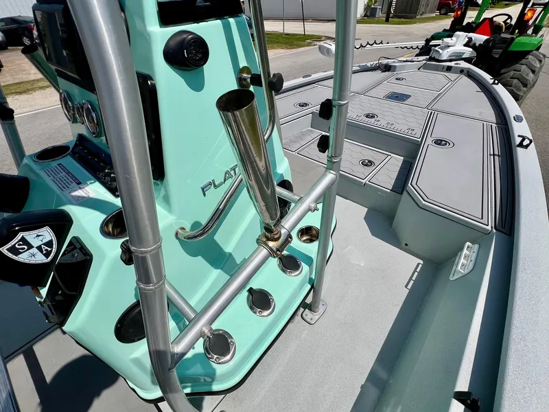 Slide: The Image of 2022 Avid 21 FS boat interior with mint green console and rod holders. - 14