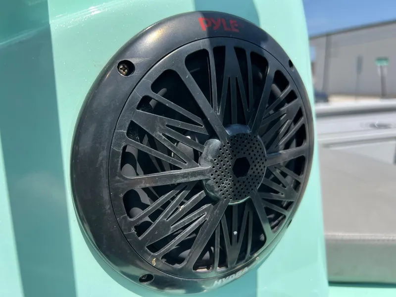 Slide: The Image of Speaker on 2022 Avid 21 FS boat, mounted on a teal surface. - 19