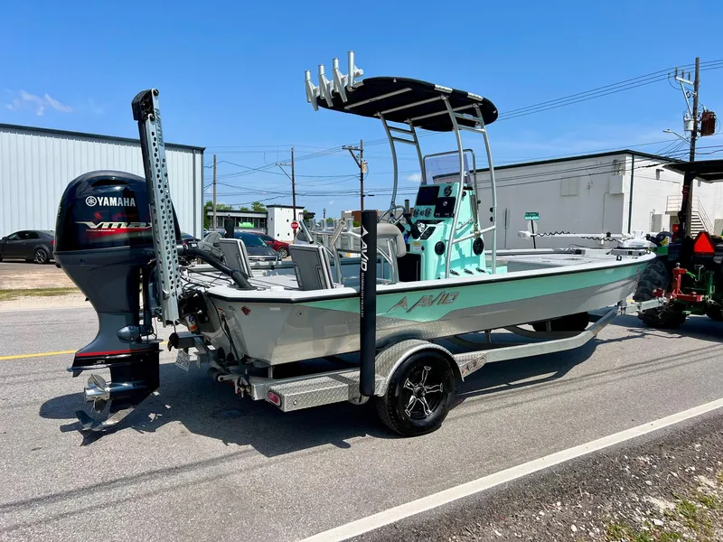 Slide: The Image of 2022 Avid 21 FS boat with Yamaha engine on trailer, parked outdoors. - 4