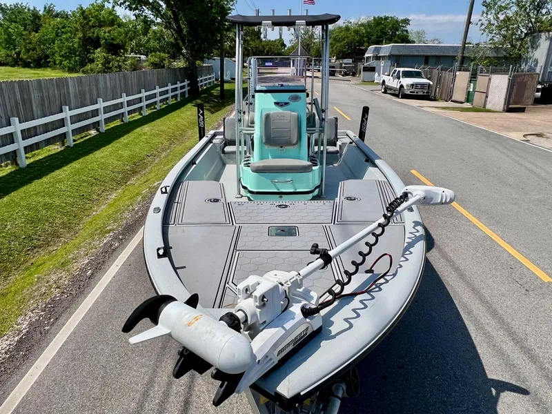 Slide: The Image of Avid 21 FS 2022 boat with trolling motor on a sunny street. - 6