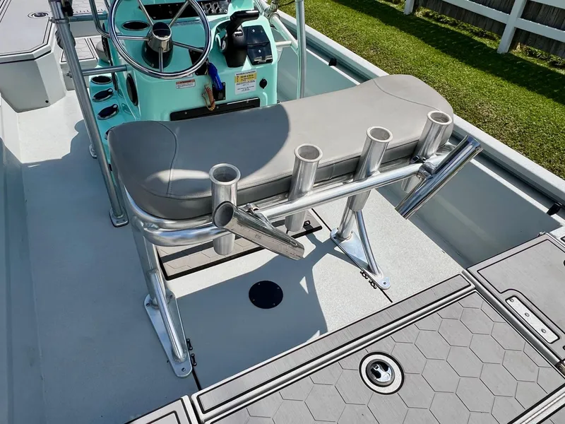 Slide: The Image of Avid 21 FS 2022 boat interior with steering console and rod holders. - 9